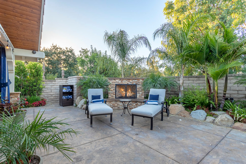 Design ideas for a large traditional backyard patio in Los Angeles with with fireplace.