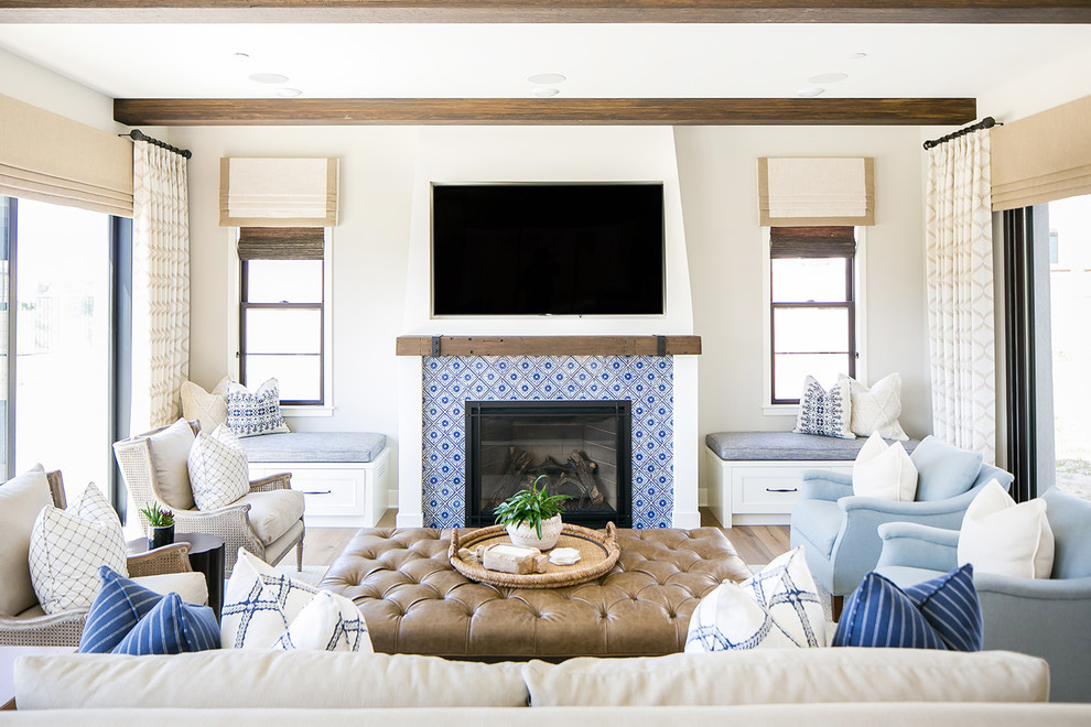 Beach style medium tone wood floor family room photo in San Diego with gray walls, a standard fireplace, a tile fireplace and a wall-mounted tv