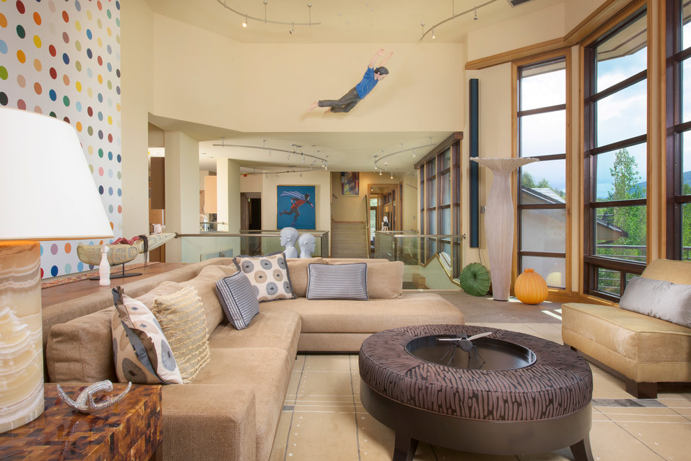 Expansive contemporary open concept living room in Denver with beige walls.