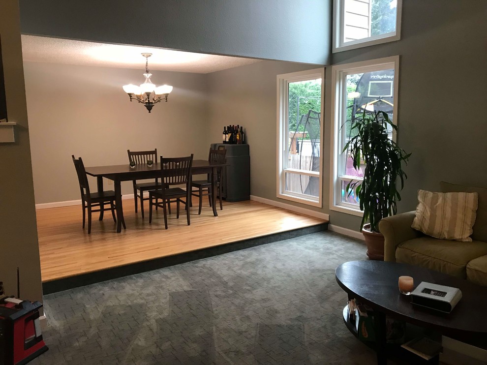 Inspiration for a mid-sized transitional light wood floor and brown floor enclosed dining room remodel in Seattle with gray walls