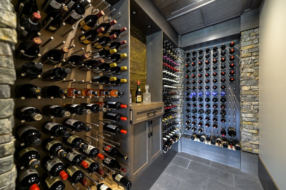 Design ideas for a large transitional wine cellar in Edmonton with porcelain floors, storage racks and grey floor.