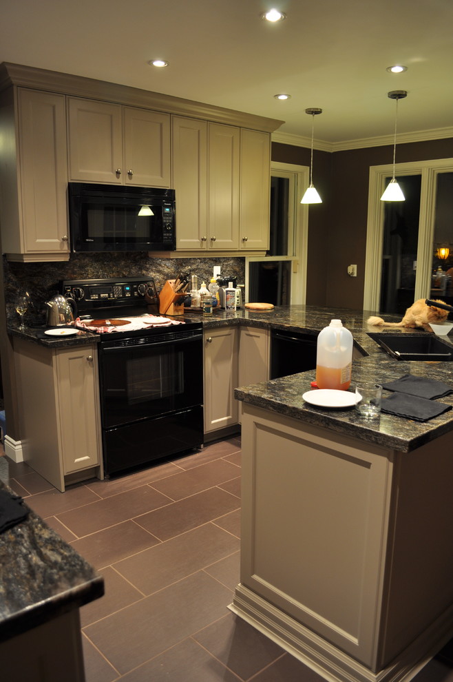 Example of a small transitional u-shaped porcelain tile open concept kitchen design in Toronto with an undermount sink, recessed-panel cabinets, gray cabinets, granite countertops, black backsplash, stone slab backsplash, paneled appliances and a peninsula