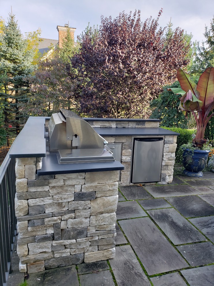 Inspiration for a backyard patio in New York with an outdoor kitchen.