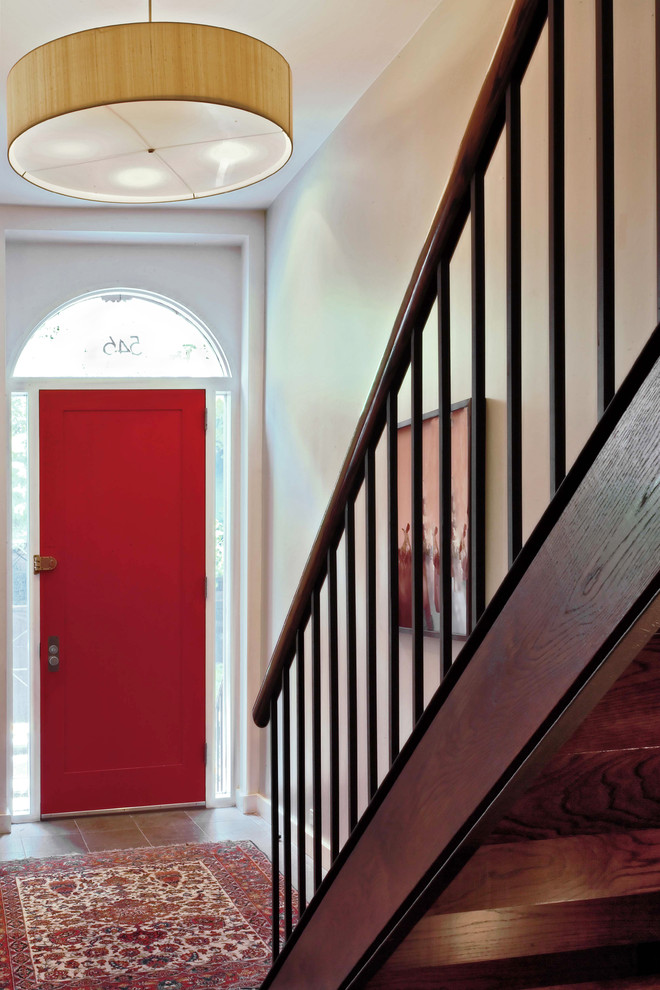 This is an example of a contemporary entryway in New York with a single front door and a red front door.