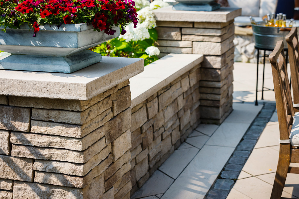 This is an example of a mid-sized rustic backyard retaining wall landscape.