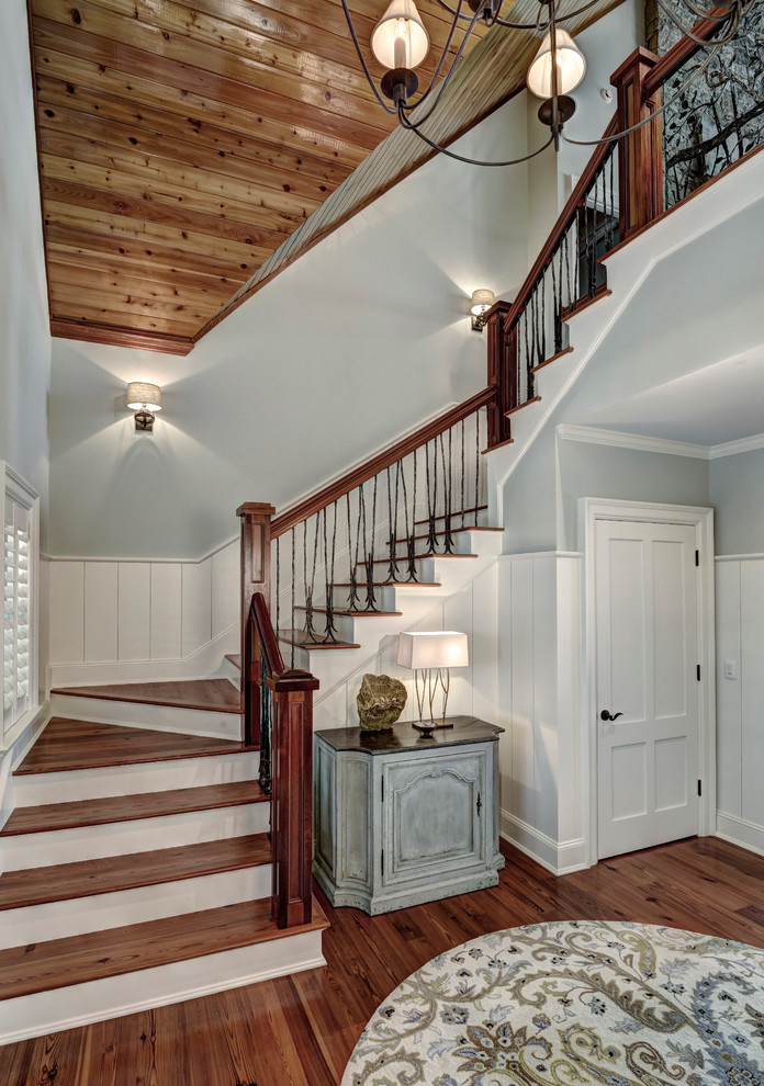Photo of a mid-sized traditional wood u-shaped staircase in Charleston with painted wood risers and mixed railing.
