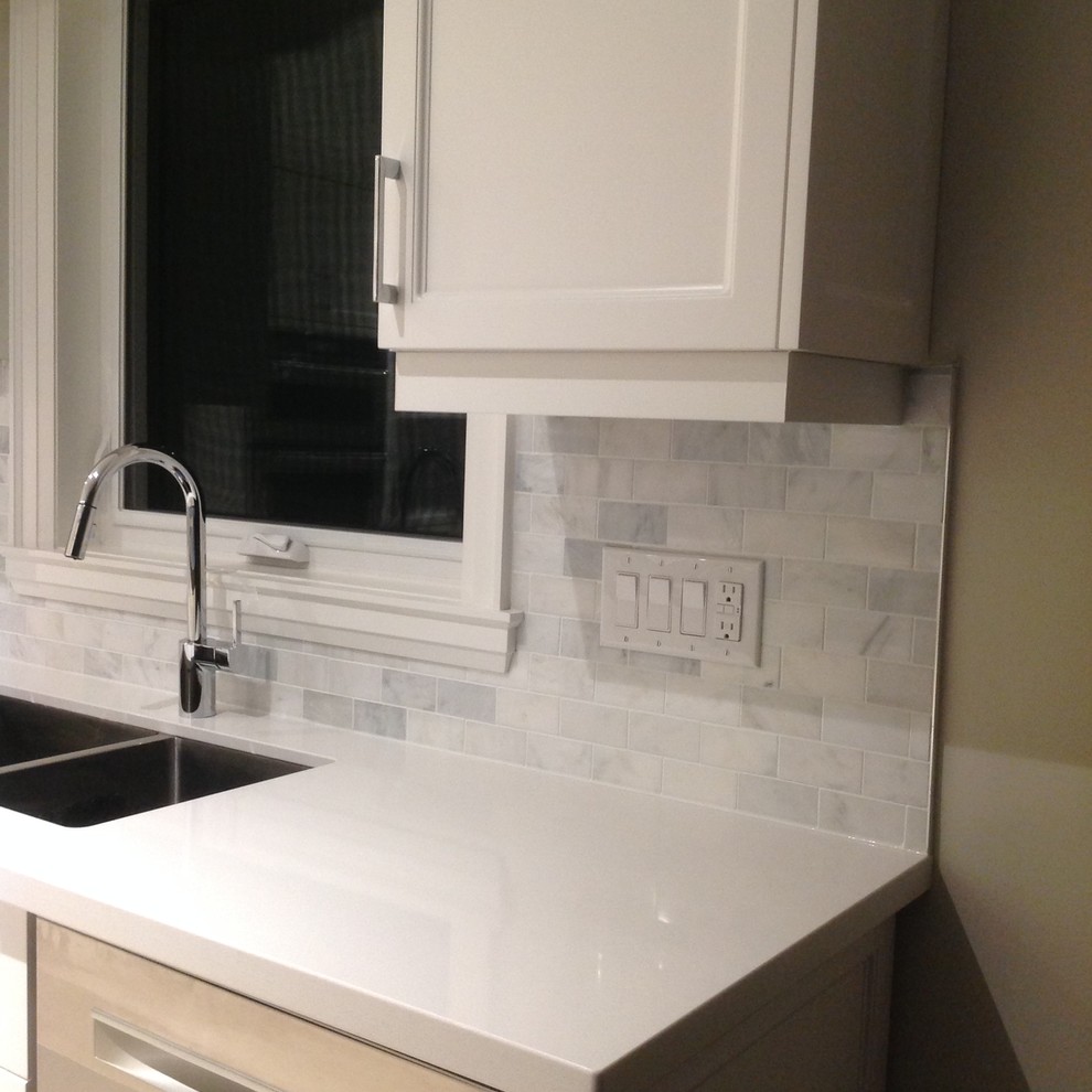 Example of a transitional kitchen design in Toronto with marble backsplash