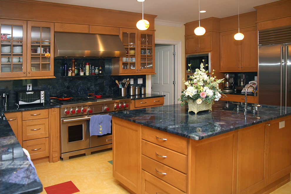 Open concept kitchen - large transitional u-shaped open concept kitchen idea with an undermount sink, recessed-panel cabinets, medium tone wood cabinets, stainless steel appliances and an island