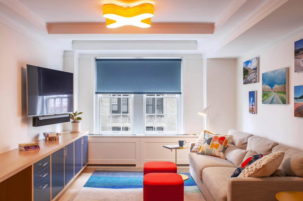 New York City Combination-Renovatin - A fun family room with amazing pops of color.  Gorgeous custom built wall unit with beautiful clear-finished oak and blue lacquer inset panels.  A surface mounted ceiling light of bentwood in a traditional beamed ceiling.  Simple blue roller shade for accents over original double-hung windows.  An area rug with multi-colors is playful.  Red upholstered poofs act as coffee tables too.  Pillow and art accents are the final touch.