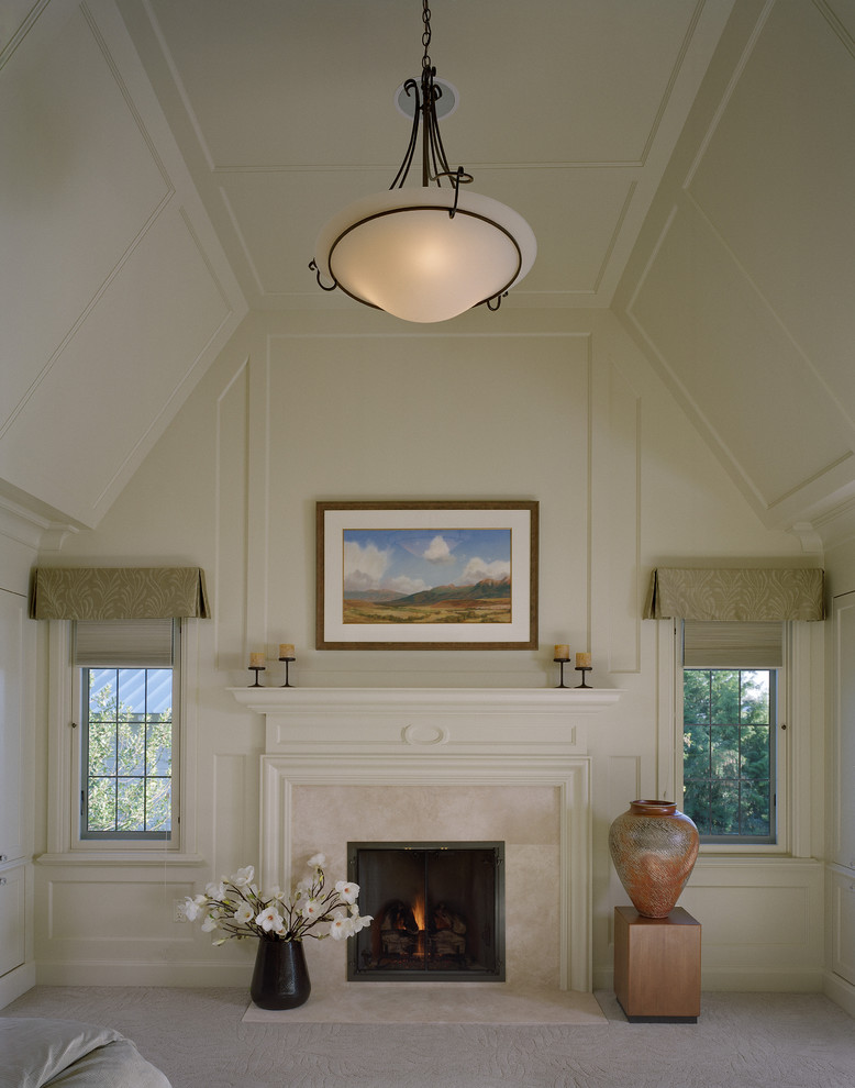 Inspiration for a traditional bedroom in Seattle with beige walls, carpet and a standard fireplace.