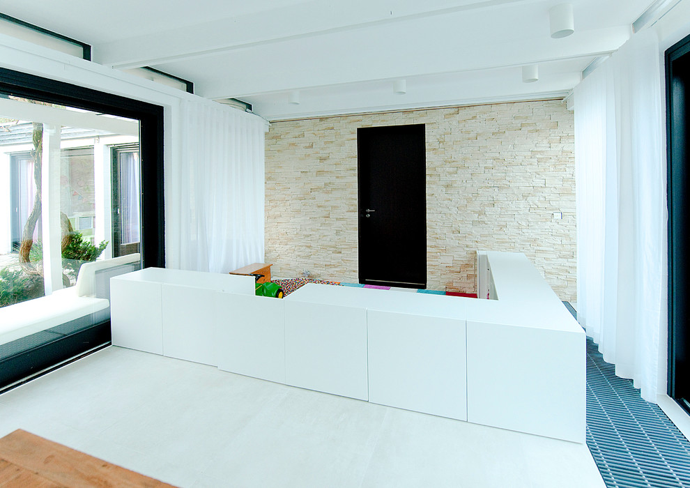 This is an example of a large contemporary open plan dining in Munich with white walls, porcelain floors, a standard fireplace and a tile fireplace surround.