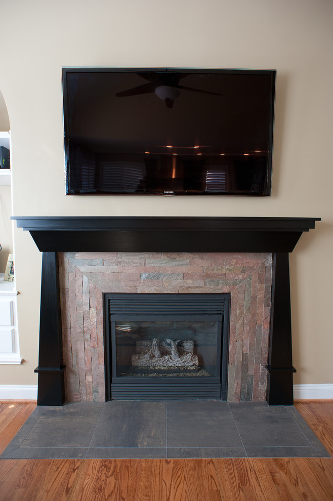 Example of a mid-sized transitional l-shaped kitchen design in Charlotte with dark wood cabinets, granite countertops, white backsplash and an island