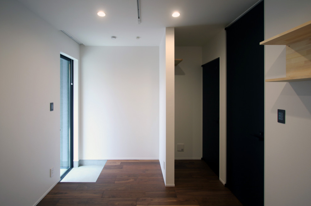Photo of a home studio in Kyoto with white walls, dark hardwood floors, brown floor, wallpaper and wallpaper.