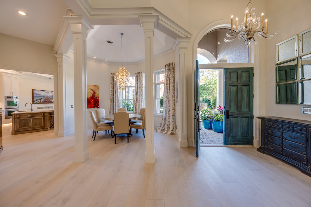 Inspiration for a transitional light wood floor, beige floor and vaulted ceiling foyer remodel with white walls and a blue front door