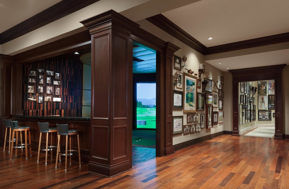This is an example of an expansive traditional hallway in Tampa with beige walls and dark hardwood floors.