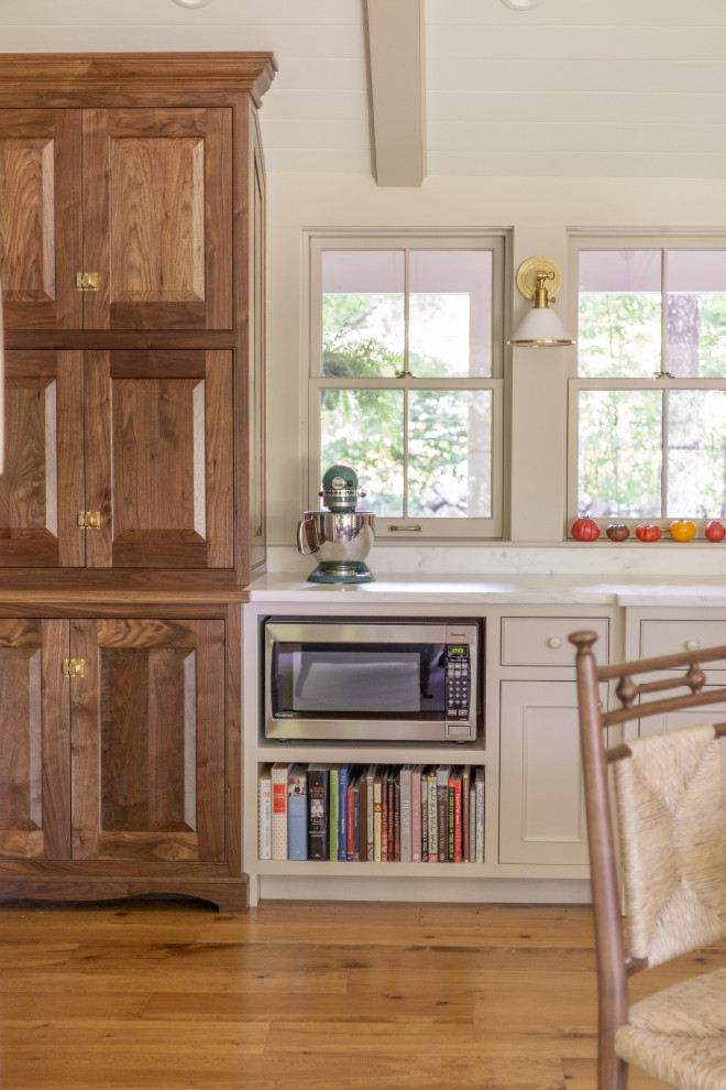 Example of a transitional vaulted ceiling open concept kitchen design in Boston with a farmhouse sink, recessed-panel cabinets, beige cabinets, marble countertops, colored appliances, no island and white countertops