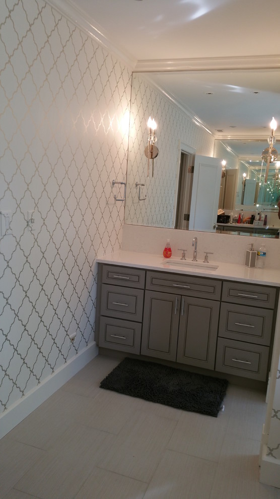 Inspiration for a transitional bathroom remodel in Chicago with flat-panel cabinets, gray cabinets, a two-piece toilet and marble countertops