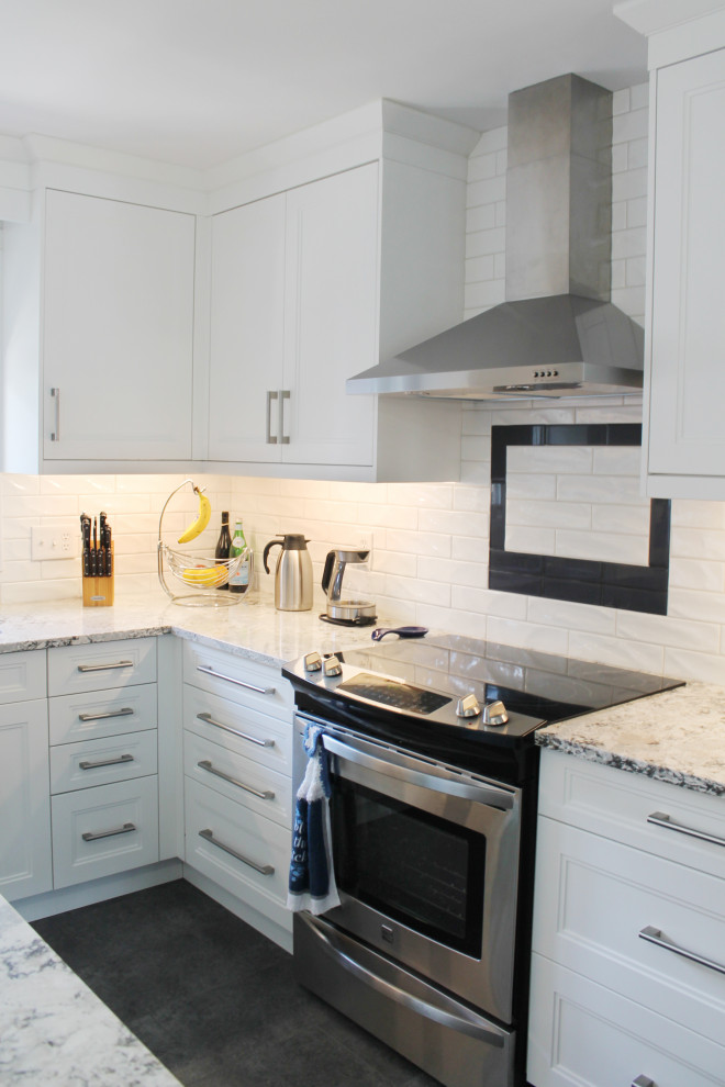Example of a large transitional u-shaped eat-in kitchen design with shaker cabinets, white cabinets, quartz countertops, white backsplash, subway tile backsplash, stainless steel appliances, an island and gray countertops