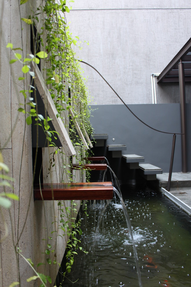 Design ideas for a contemporary garden in Other with a water feature.
