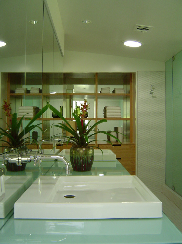 Inspiration for a large midcentury master bathroom in Los Angeles with flat-panel cabinets, medium wood cabinets, a drop-in tub, a corner shower, white tile, mosaic tile, white walls, mosaic tile floors, a vessel sink, glass benchtops, white floor and a hinged shower door.
