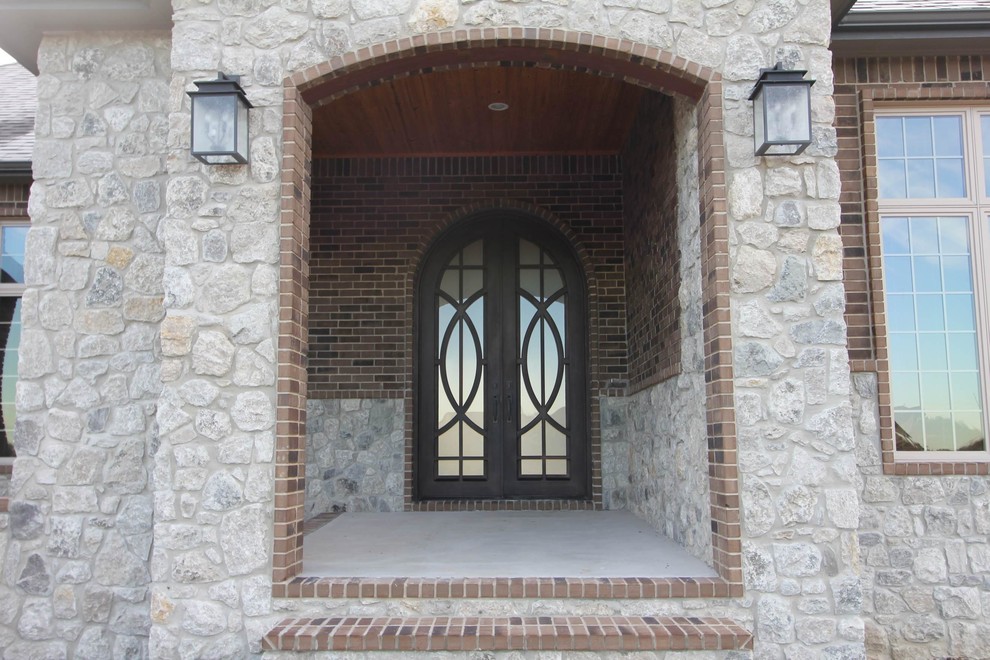 Design ideas for a mid-sized mediterranean two-storey brick brown house exterior in Wichita.