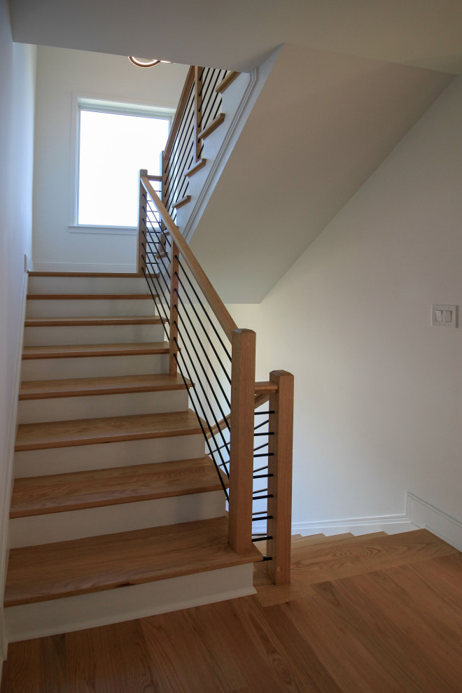This is an example of a medium sized contemporary wood floating mixed railing staircase in DC Metro with painted wood risers and tongue and groove walls.