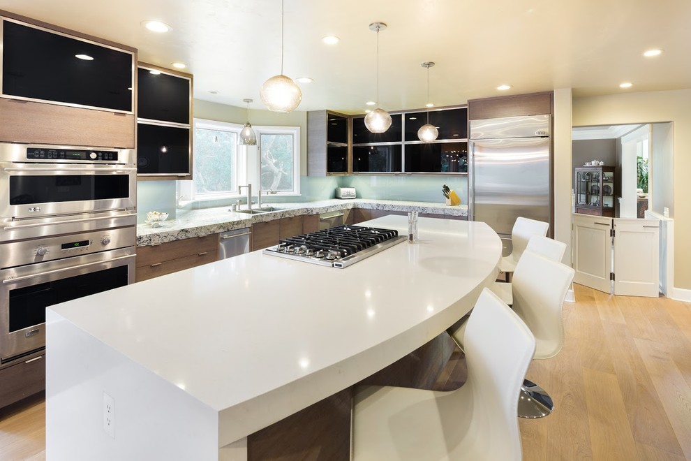 Inspiration for a large eclectic eat-in kitchen in San Francisco with an undermount sink, flat-panel cabinets, light wood cabinets, quartz benchtops, stainless steel appliances and with island.