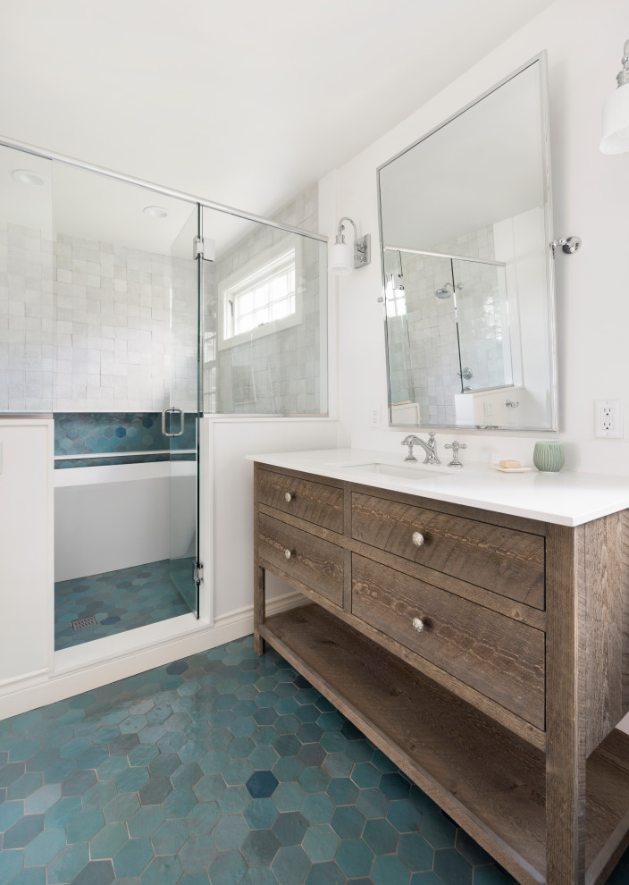 Design ideas for a mid-sized transitional master bathroom in Portland with flat-panel cabinets, distressed cabinets, a freestanding tub, a shower/bathtub combo, a one-piece toilet, multi-coloured tile, ceramic tile, white walls, ceramic floors, an undermount sink, engineered quartz benchtops, blue floor, a hinged shower door, white benchtops, a niche, a single vanity and a freestanding vanity.