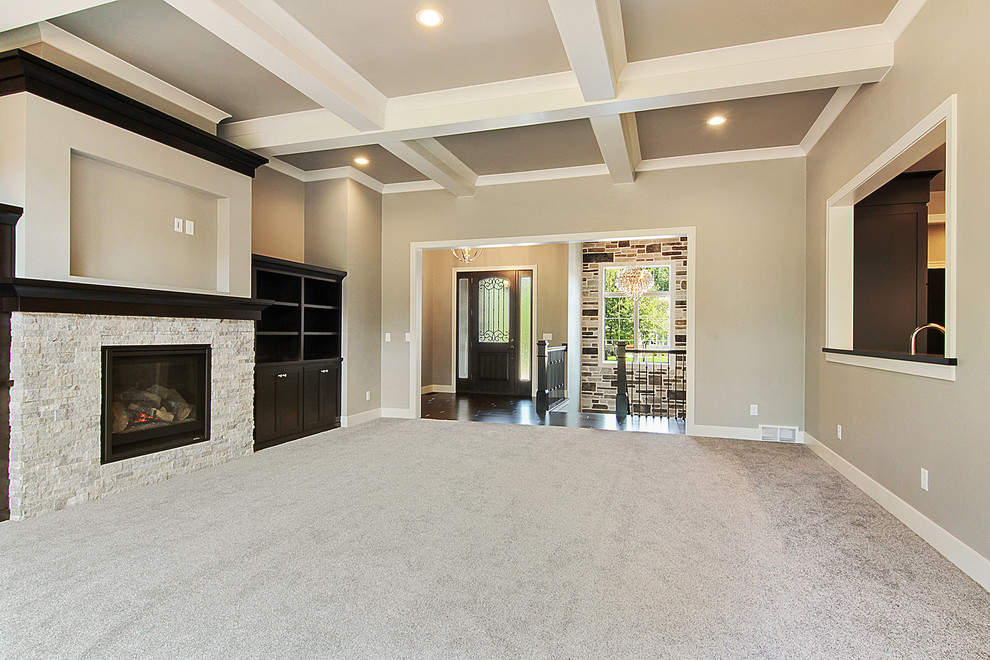 This is an example of a traditional formal open concept living room in Other with grey walls, cork floors, a standard fireplace, a stone fireplace surround, a built-in media wall and grey floor.
