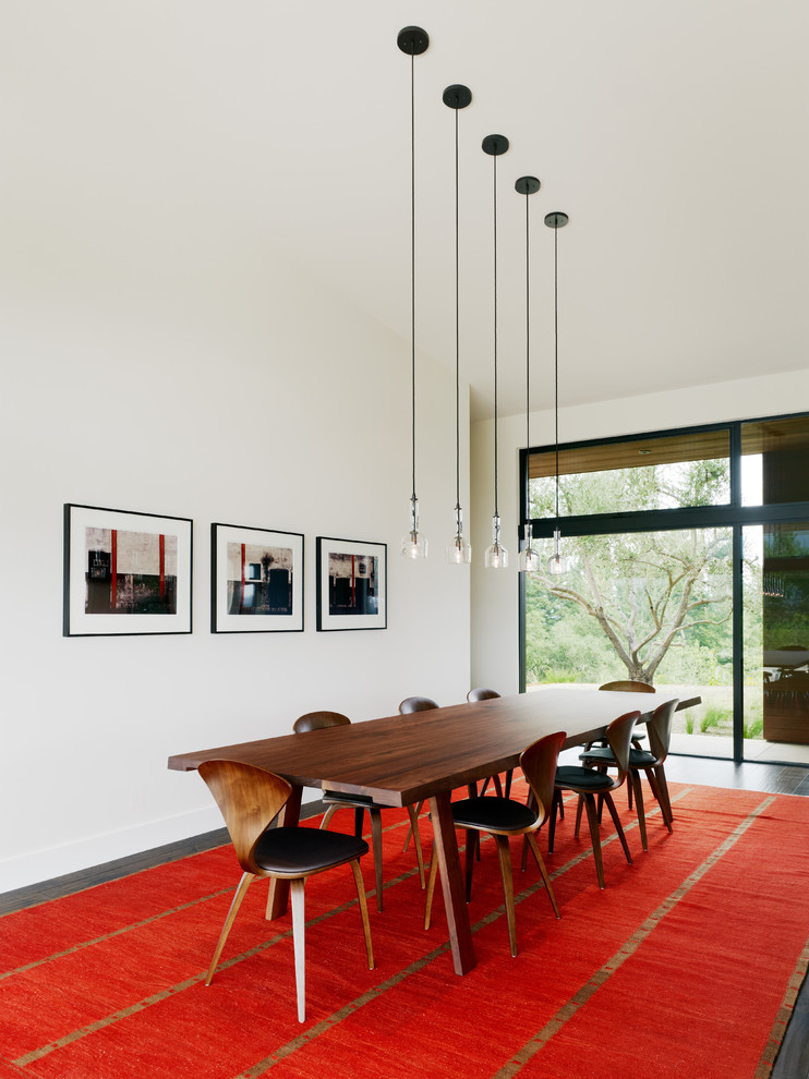 Midcentury dining room in San Francisco with white walls and dark hardwood floors.