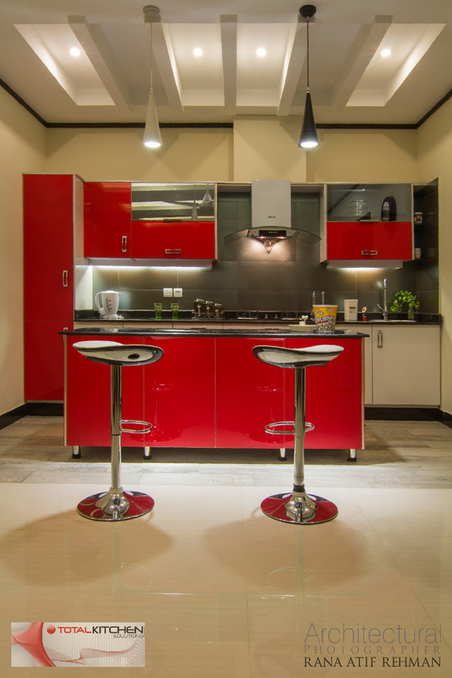 Design ideas for a small contemporary single-wall separate kitchen in Other with a drop-in sink, flat-panel cabinets, red cabinets, laminate benchtops, grey splashback, glass tile splashback, stainless steel appliances, ceramic floors and with island.