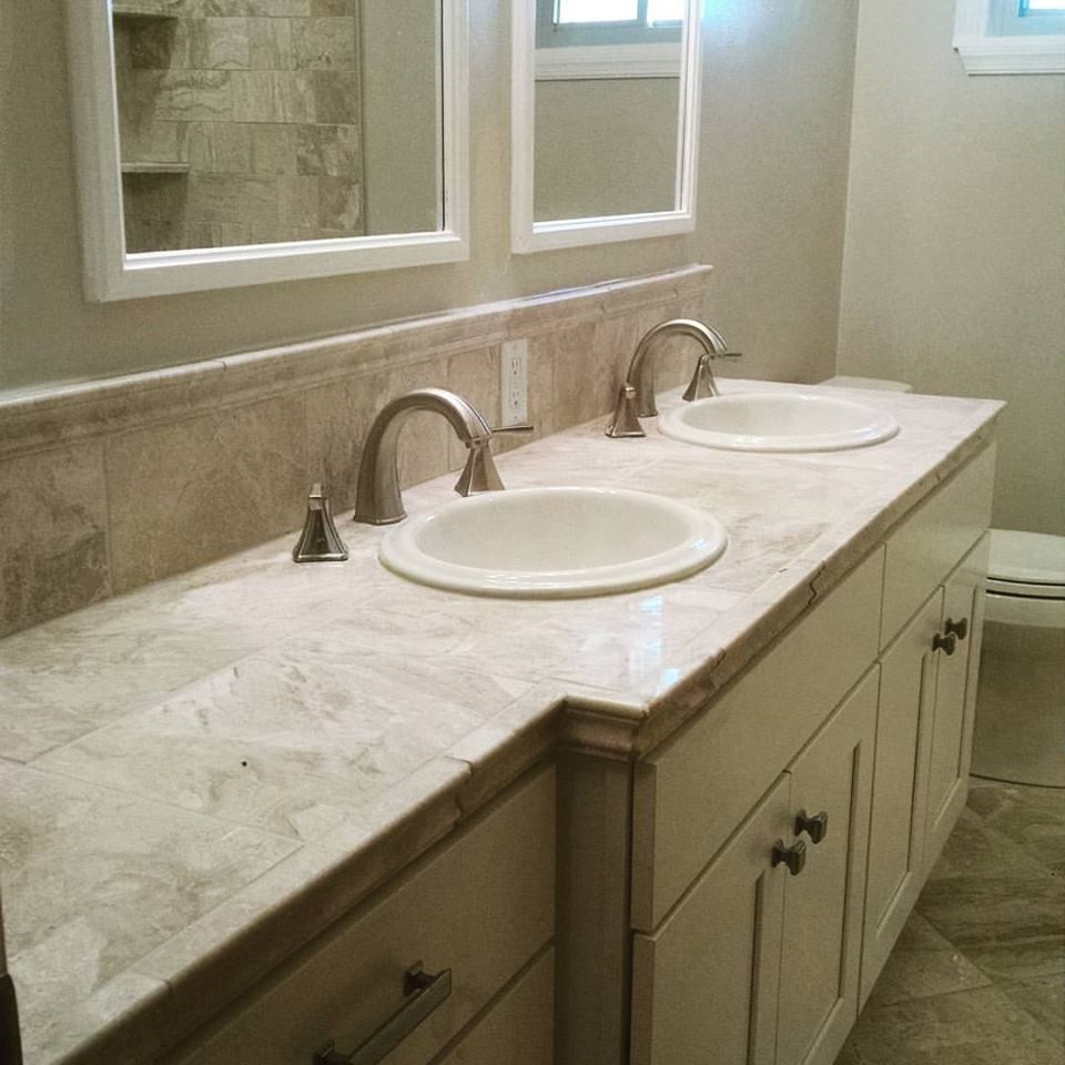 Design ideas for a mid-sized traditional master bathroom in Other with shaker cabinets, white cabinets, an alcove tub, a shower/bathtub combo, a two-piece toilet, beige tile, stone tile, beige walls, travertine floors, a drop-in sink, tile benchtops and beige floor.