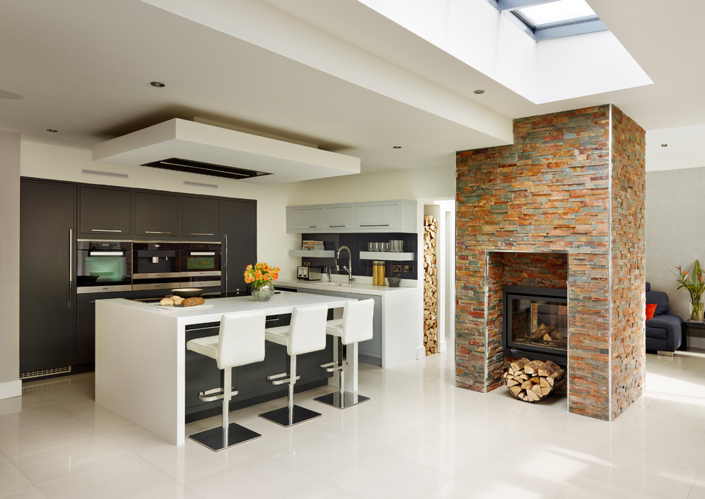 Inspiration for a contemporary kitchen in London with with island.