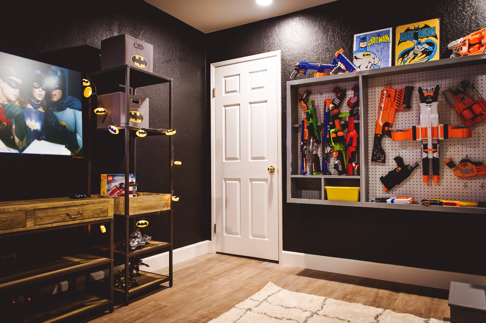 Design ideas for a mid-sized eclectic kids' bedroom for kids 4-10 years old and boys in San Diego with black walls and light hardwood floors.