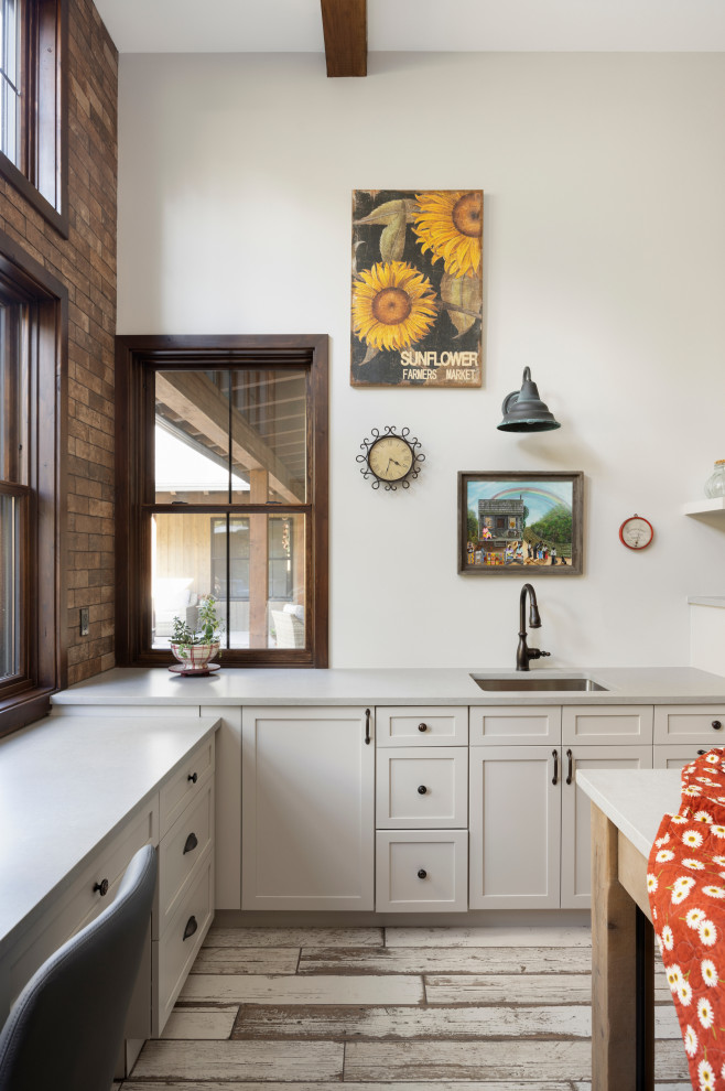 Design ideas for a country u-shaped utility room in Denver with an undermount sink, shaker cabinets, white cabinets, quartzite benchtops, white walls, ceramic floors, a side-by-side washer and dryer and grey benchtop.