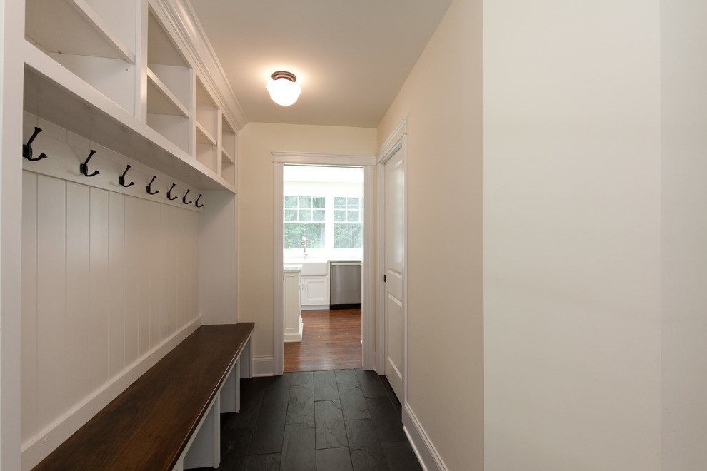 This is an example of a small country hallway in Chicago with yellow walls, slate floors and black floor.