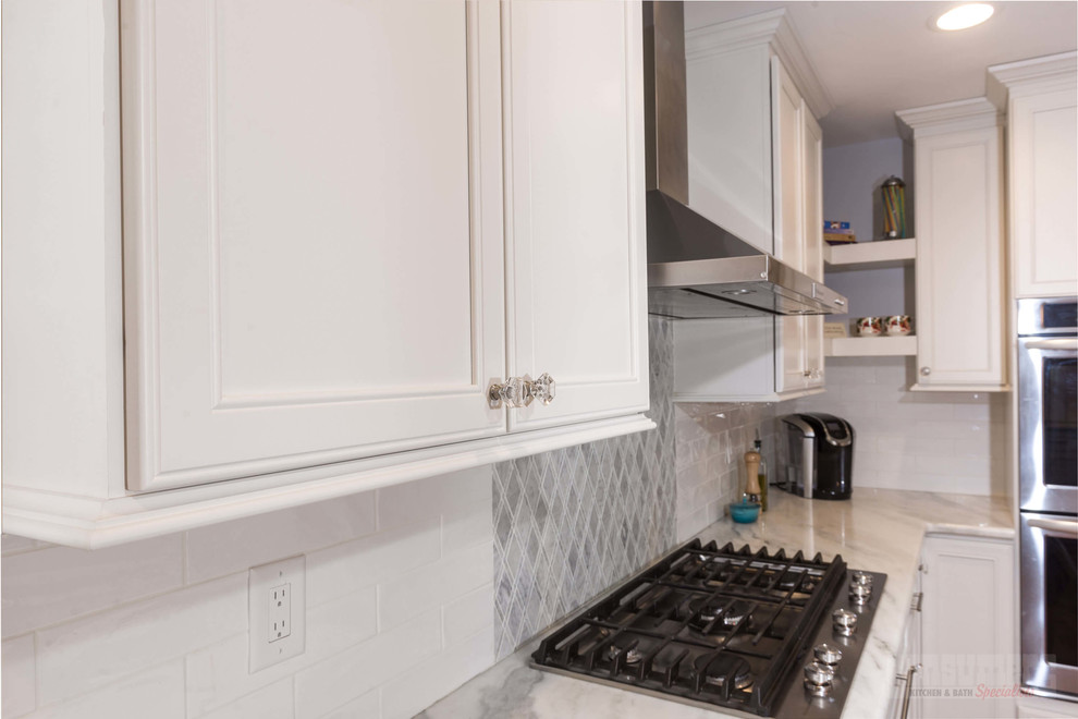 This is an example of a large u-shaped eat-in kitchen in New York with an undermount sink, flat-panel cabinets, white cabinets, quartzite benchtops, white splashback, porcelain splashback, stainless steel appliances, plywood floors and with island.
