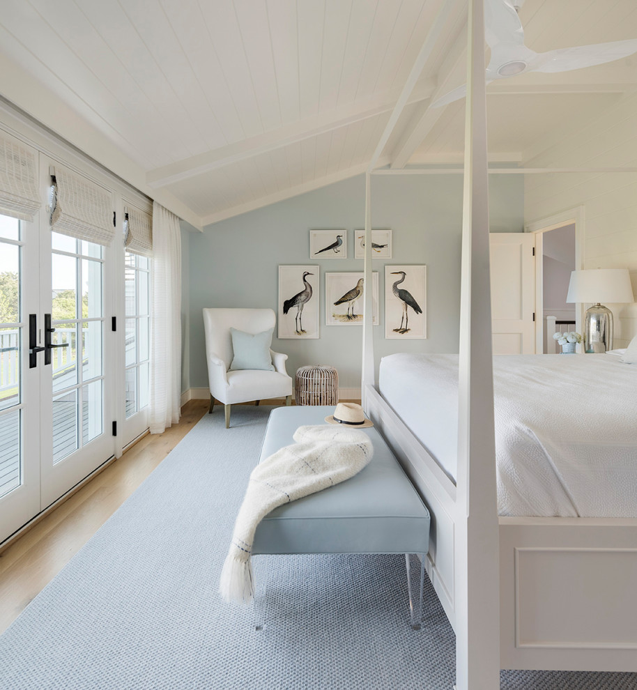 This is an example of a beach style bedroom in Providence with blue walls, light hardwood floors, beige floor, timber and vaulted.