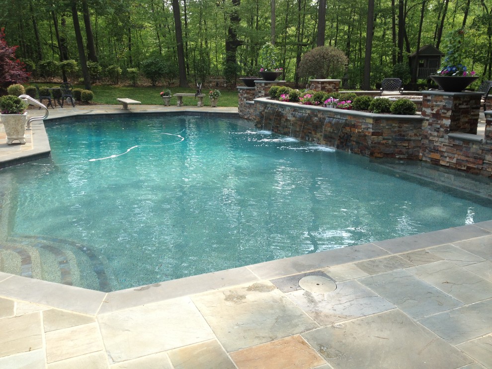Large transitional backyard tile and rectangular lap pool fountain photo in Detroit