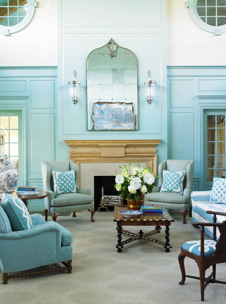 This is an example of a beach style formal living room in New York with blue walls, a standard fireplace and no tv.