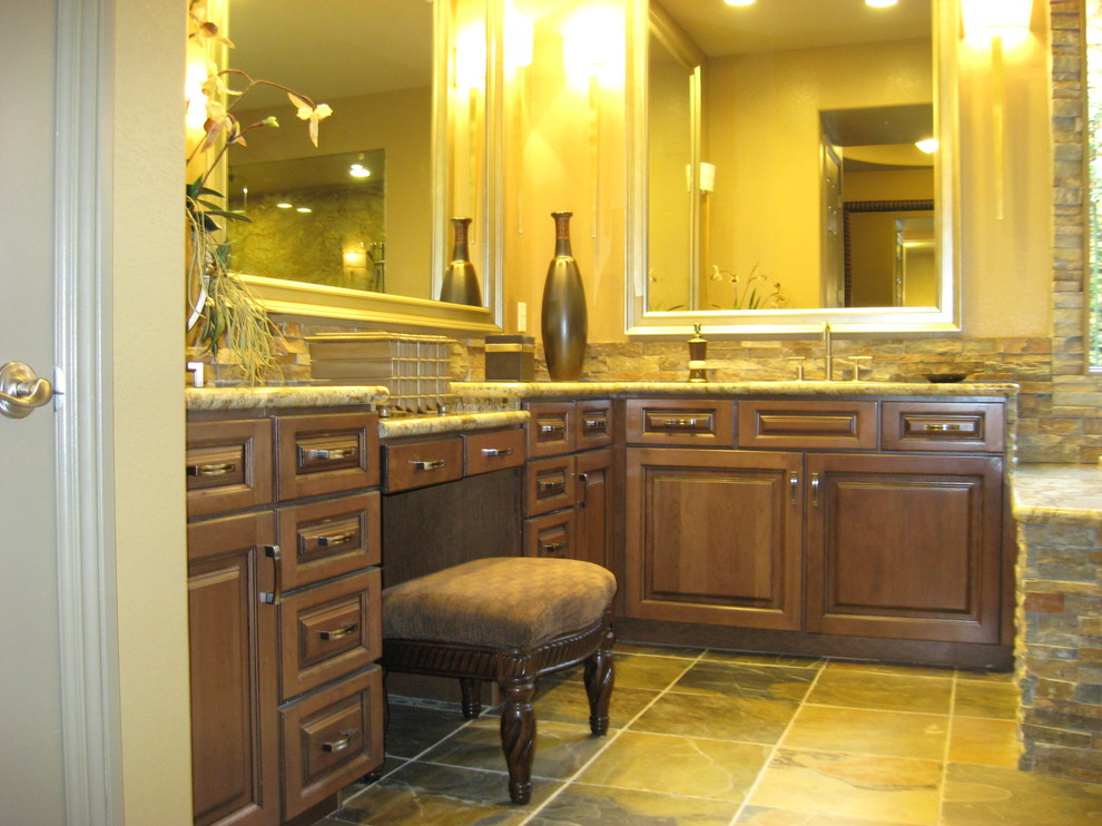 Design ideas for a large traditional master bathroom in Las Vegas with an undermount sink, furniture-like cabinets, medium wood cabinets, granite benchtops, a drop-in tub, a corner shower, a two-piece toilet, multi-coloured tile, stone tile, beige walls and slate floors.