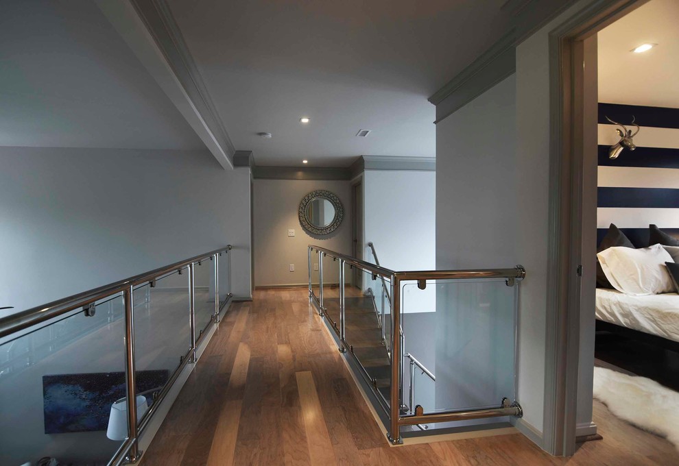 Inspiration for a large modern hallway in Baltimore with grey walls and light hardwood floors.