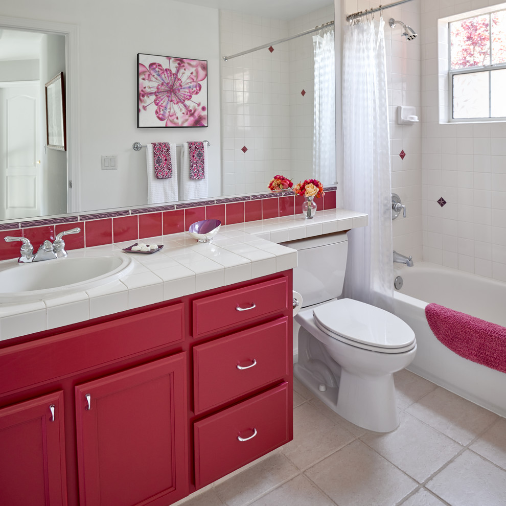 Transitional bathroom in San Francisco with recessed-panel cabinets, red cabinets, an alcove tub, a shower/bathtub combo, white tile, white walls, a drop-in sink, tile benchtops, beige floor, a shower curtain and white benchtops.