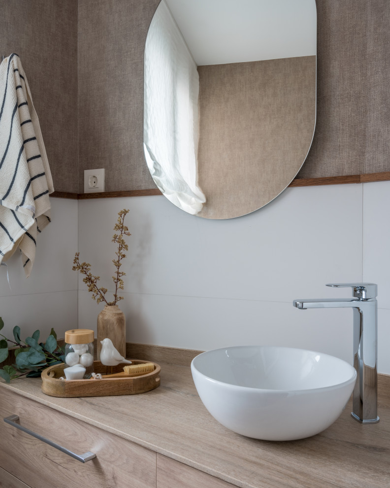 Inspiration for a small classic cloakroom in Bilbao with flat-panel cabinets, medium wood cabinets, a one-piece toilet, white tiles, ceramic tiles, brown walls, ceramic flooring, a vessel sink, limestone worktops, multi-coloured floors, brown worktops, a built in vanity unit and wallpapered walls.