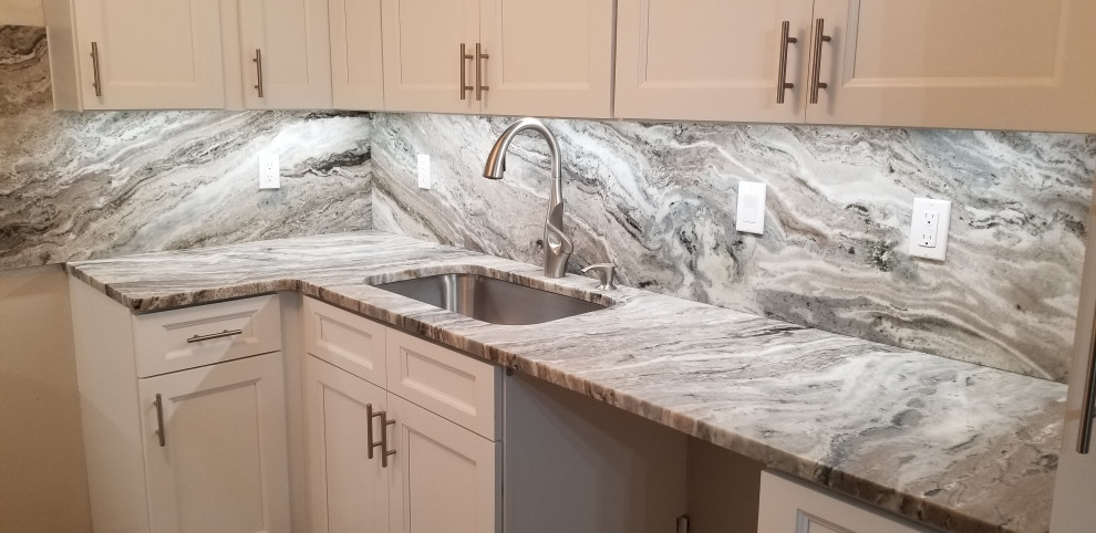 Inspiration for a laundry room in Miami with an undermount sink, recessed-panel cabinets, white cabinets, granite benchtops, grey splashback, granite splashback and grey benchtop.