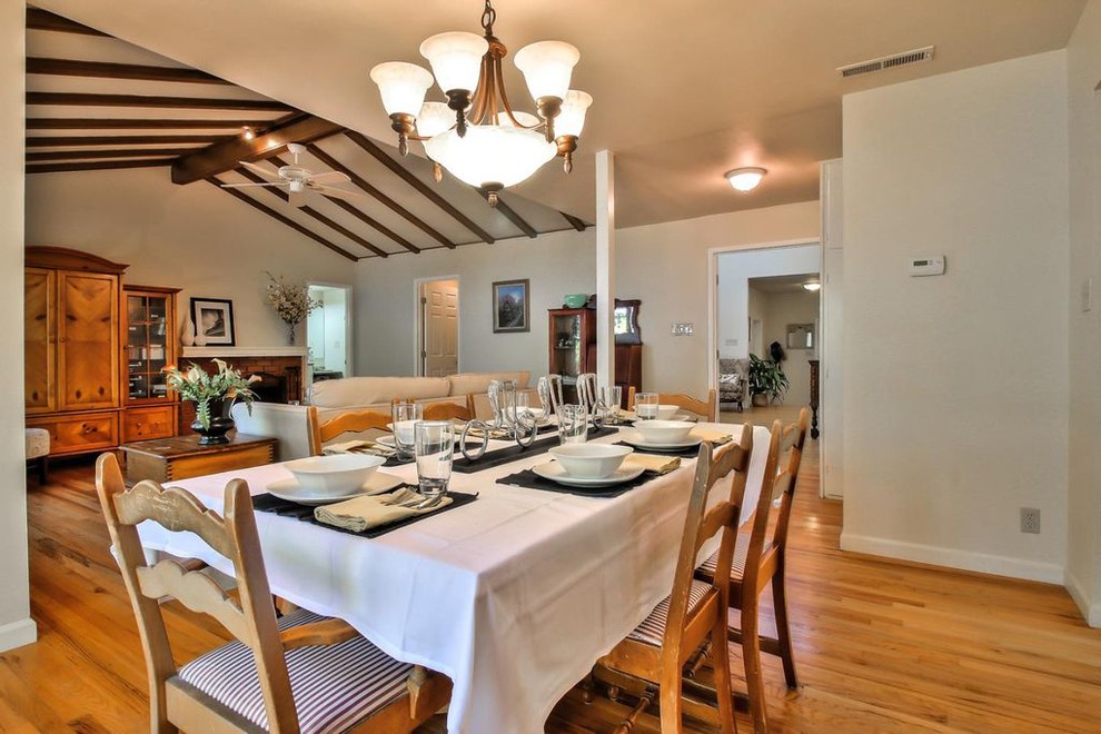 This is an example of a mid-sized traditional open plan dining in San Francisco with beige walls, light hardwood floors, no fireplace and beige floor.