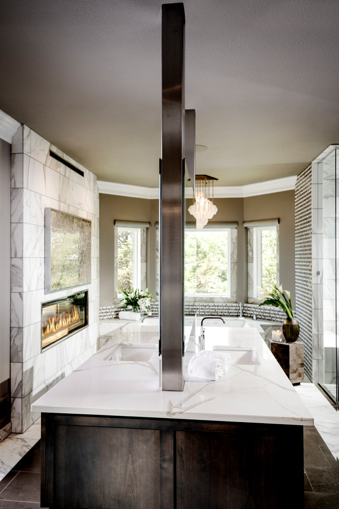 Photo of a large modern master bathroom in Other with recessed-panel cabinets, dark wood cabinets, an undermount tub, a corner shower, gray tile, marble, grey walls, marble floors, an undermount sink, quartzite benchtops, white floor, an open shower and white benchtops.