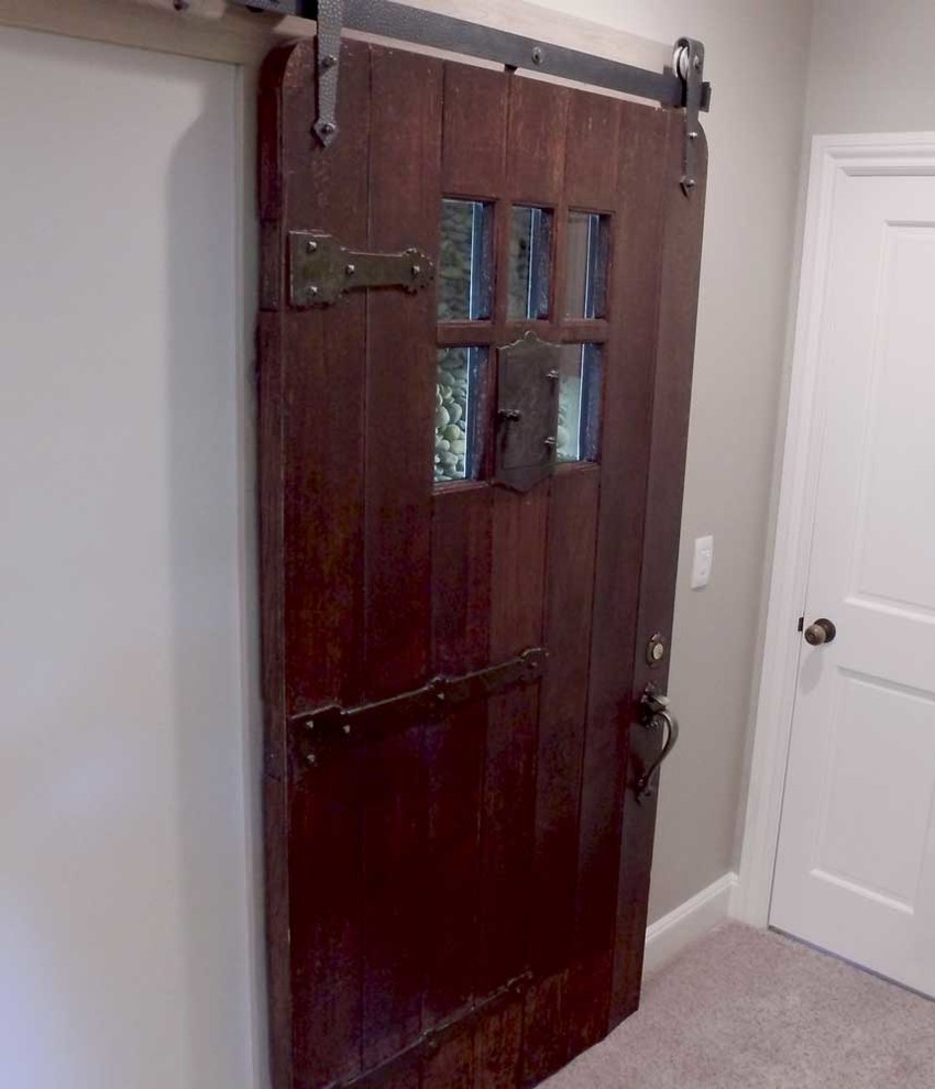 Photo of a mid-sized modern front door in Wichita with grey walls, carpet and a dark wood front door.