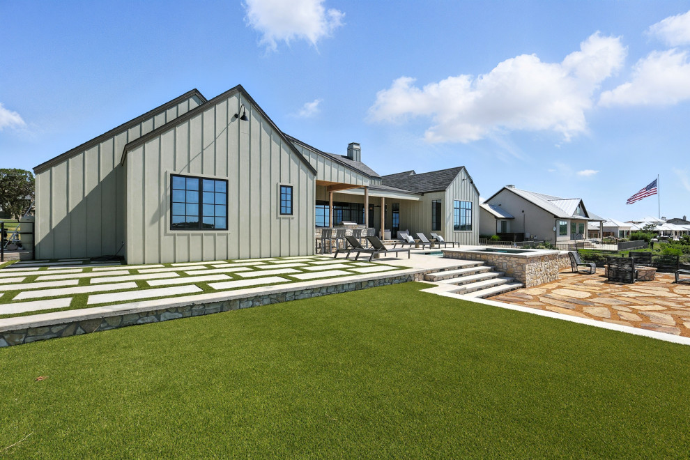 Large minimalist backyard rectangular pool photo in Dallas