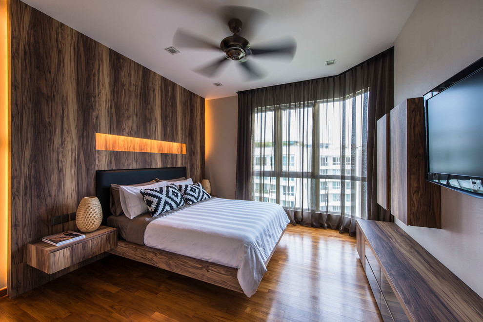 Photo of a contemporary bedroom in Singapore with beige walls and dark hardwood floors.